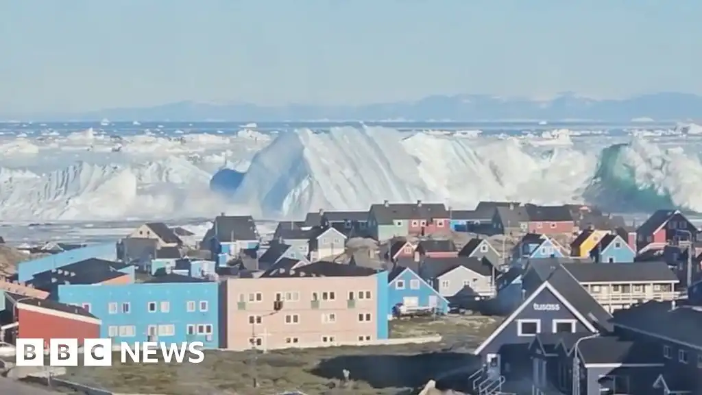 Giant iceberg turns over near Greenland's coast