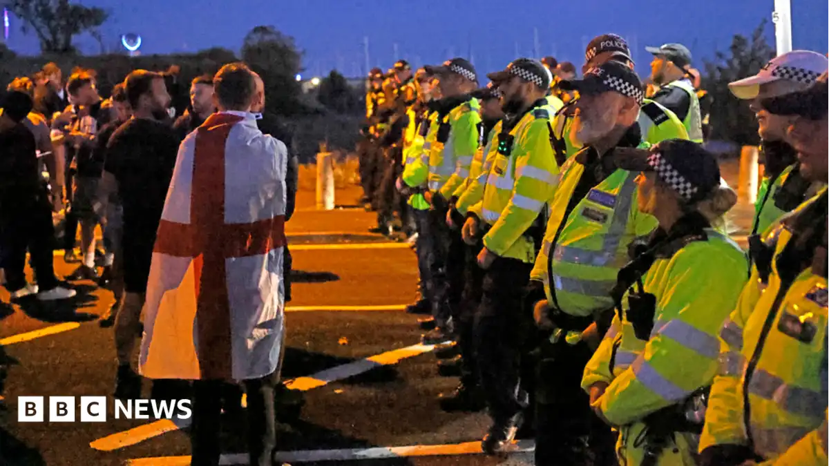 Protesters scuffle with police as migrants brought ashore on south coast