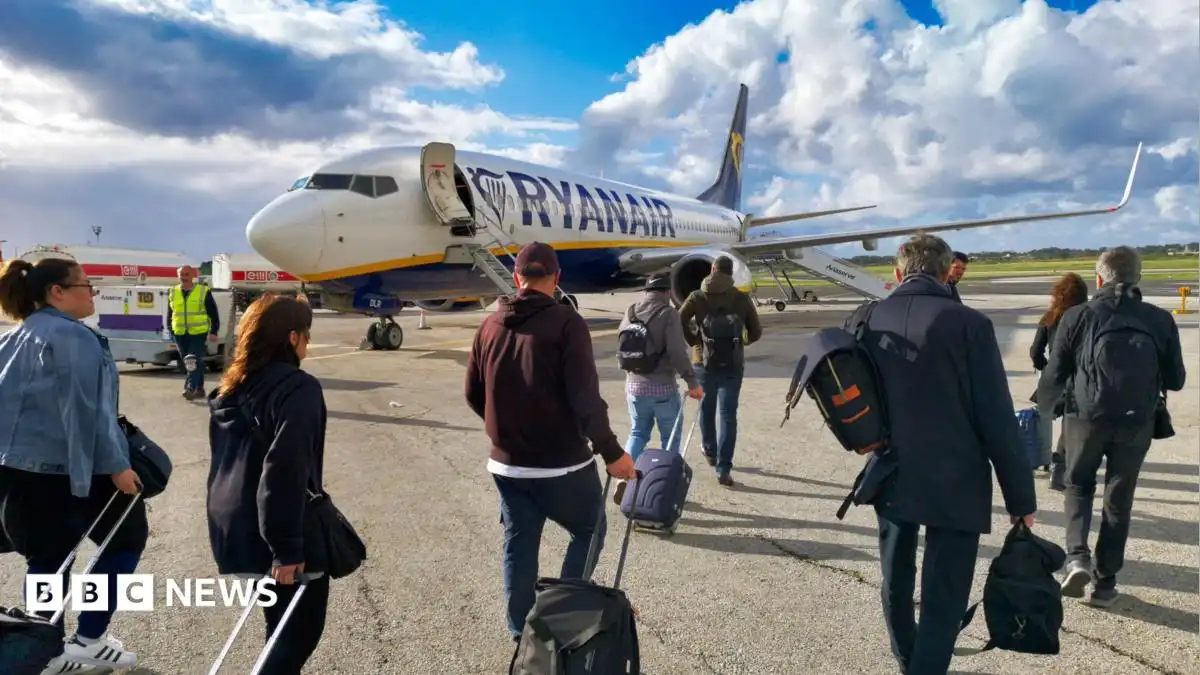 Ryanair says it will reluctantly not charge parents to sit next to children