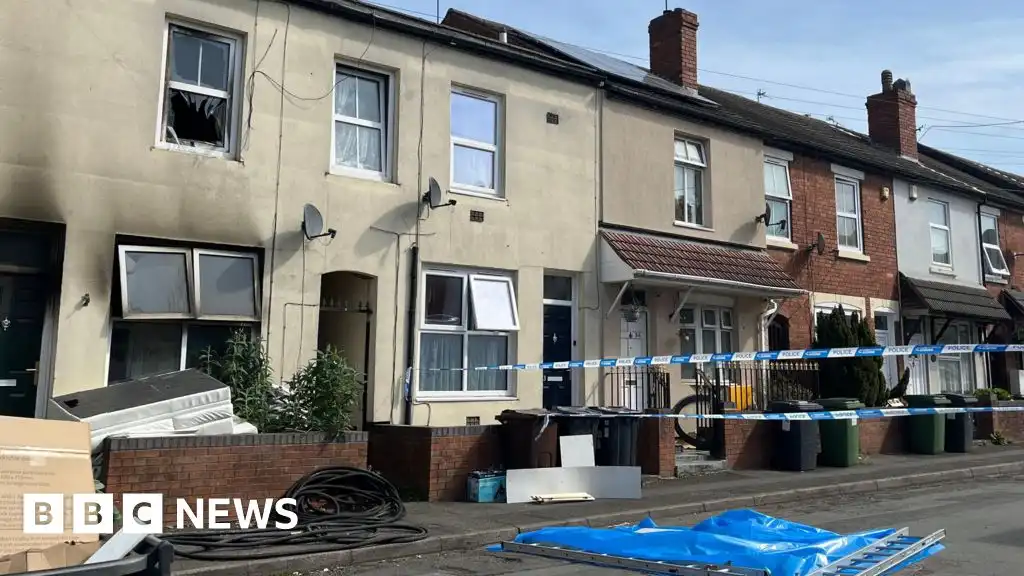 Woman arrested after two children die in house fire